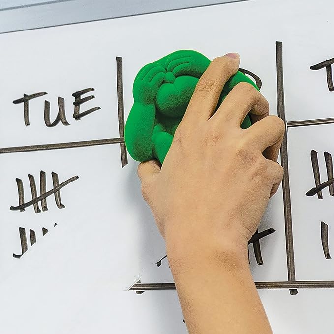 Using green magnetic monkey white board eraser and marker holder to clean up after lesson.