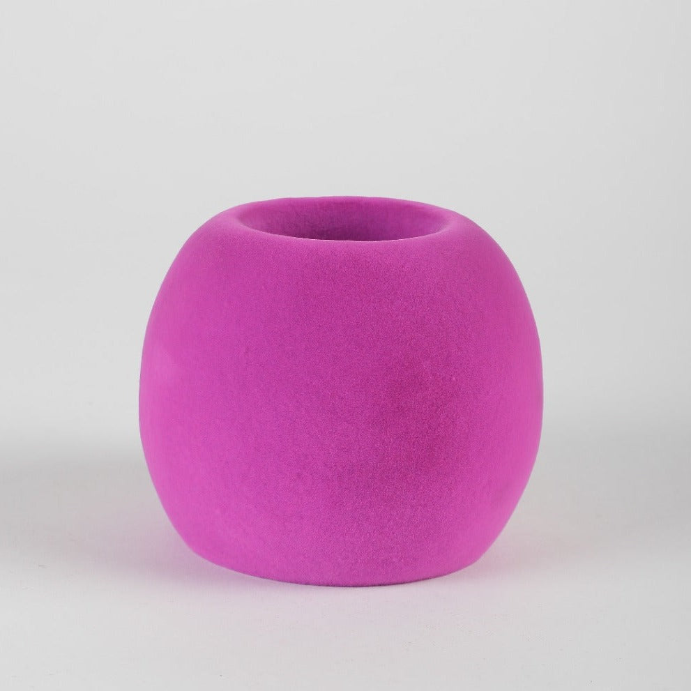 Bright pink round pen stand made from biodegradable rubber foam for eco-friendly desk organization